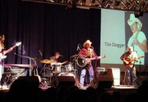 Man with guitar on stage