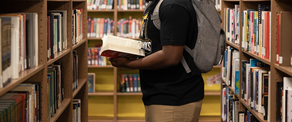 Student reading in library