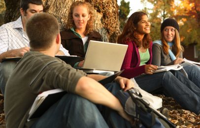 Group of college students outdoors studying.