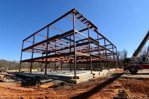 construction site showing foundation work and steel structure