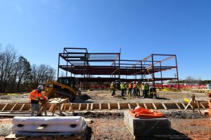 construction site showing foundation work and steel structure