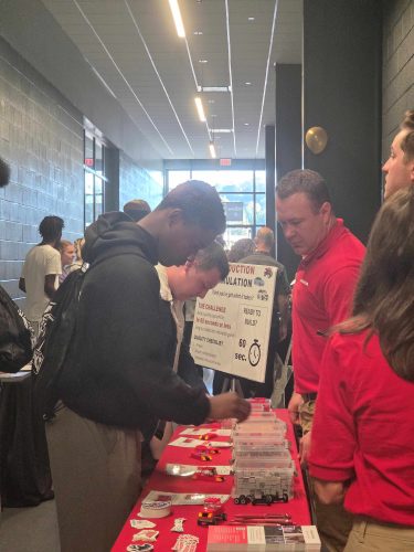 attendees visiting a booth