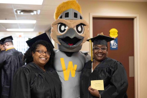 two graduates with knightro