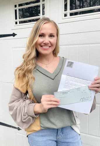 Haylee Burgess holding her scholarship lettter