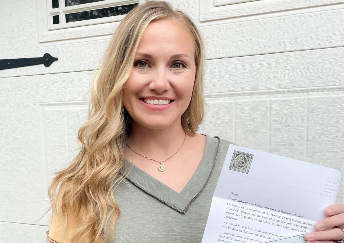 Haylee Burgess holding her scholarship lettter