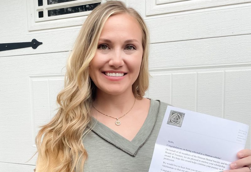 Haylee Burgess holding her scholarship lettter