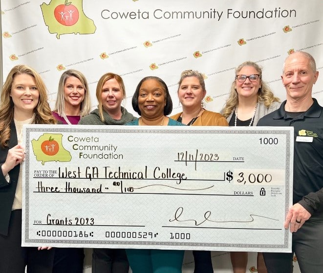 Ashley Akins, WGTC Foundation Coordinator; Dr. Tonya Whitlock, VP of Student Affairs; Brittney Wells, WGTC Foundation Executive Director, and Melinda Hofius, Dean of Students accept a check from members of the Coweta Community Foundation. The grant will support the College’s Project CARE initiative.