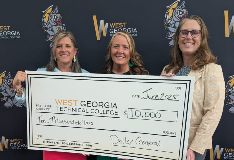 WGTC employees holding a large check