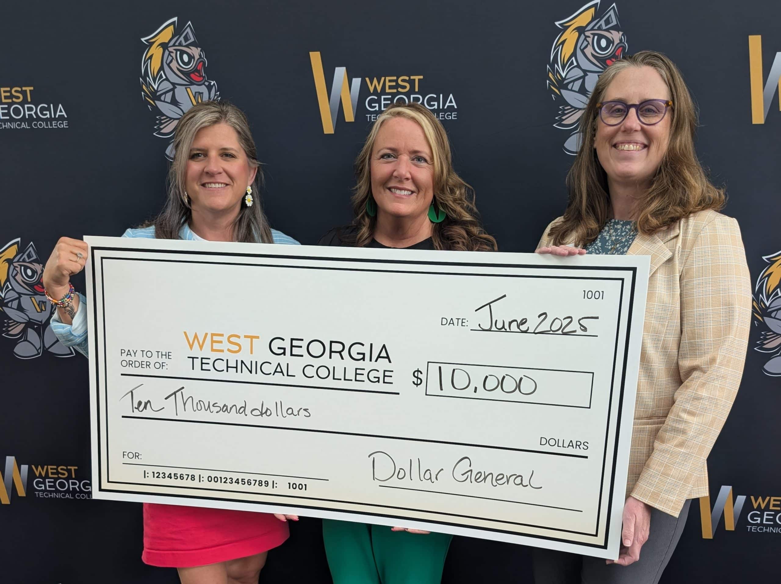 WGTC employees holding a large check