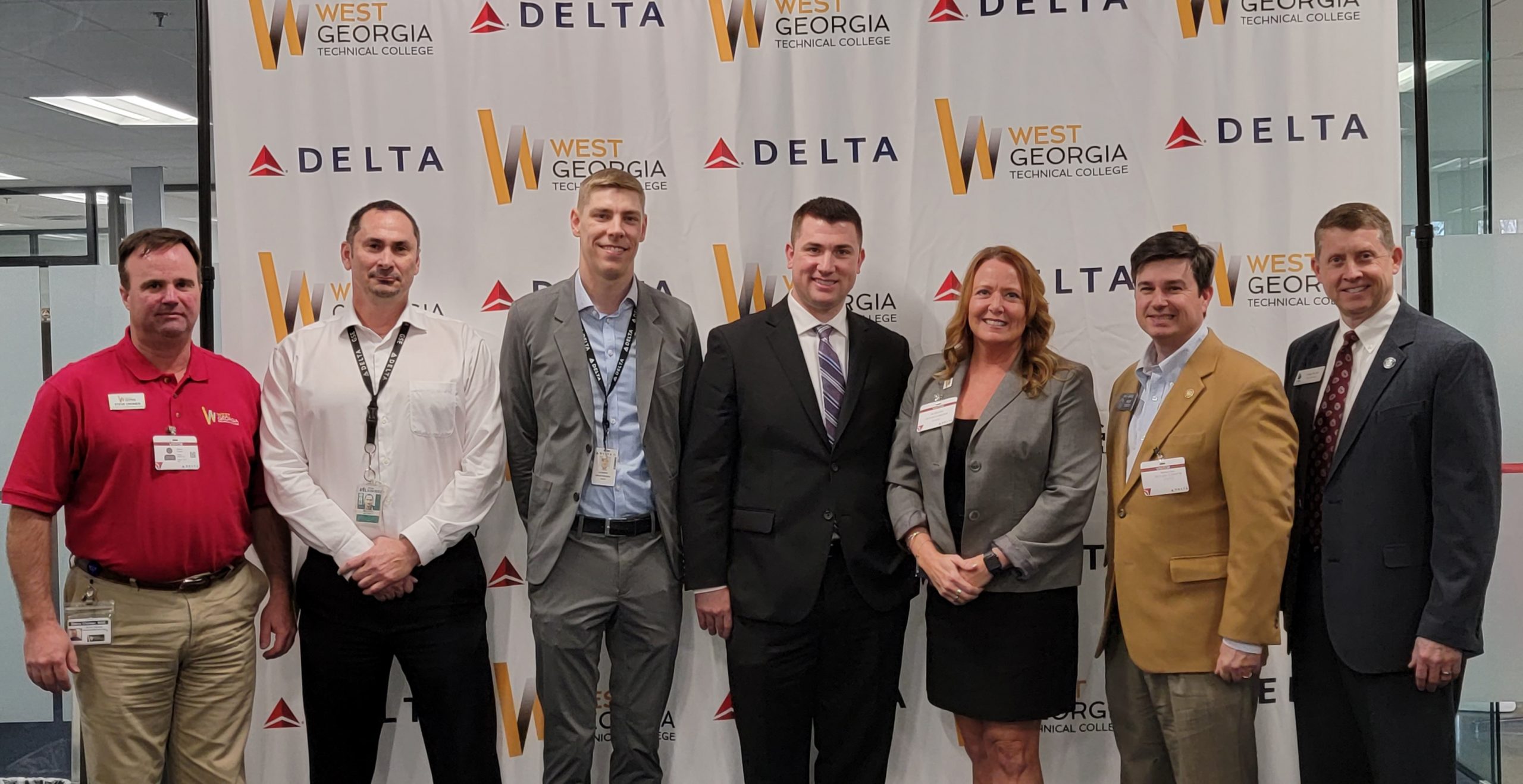 individuals in front of Delta and wgtc logos