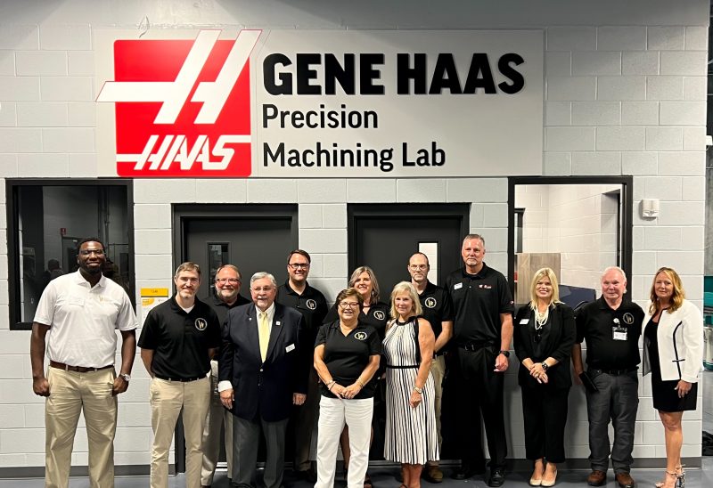 Individuals standing in front of Gene Haas Lab