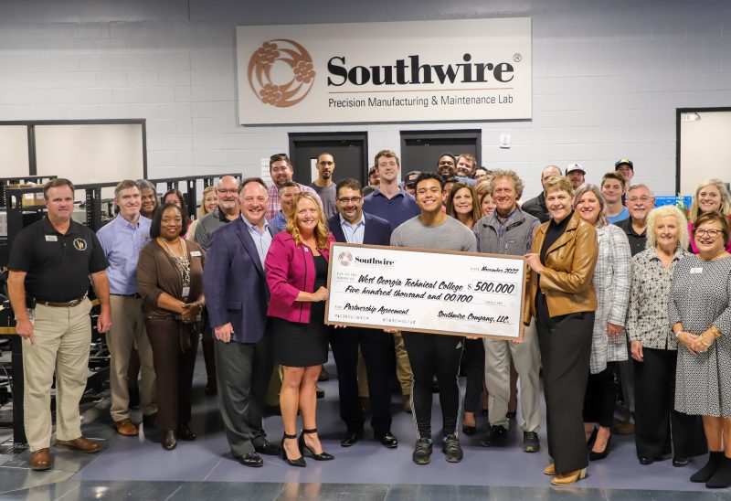 individuals holding large check