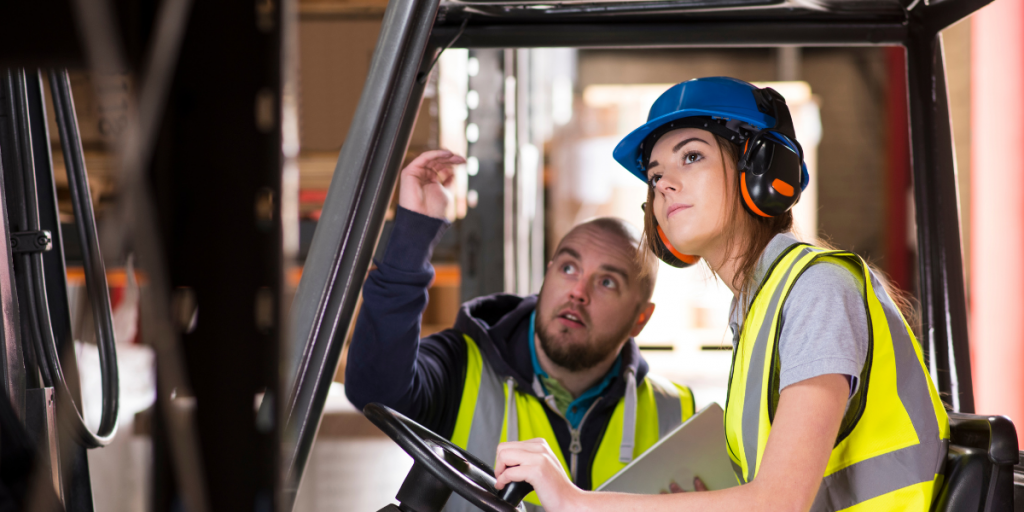 Forklift driving student with instructor