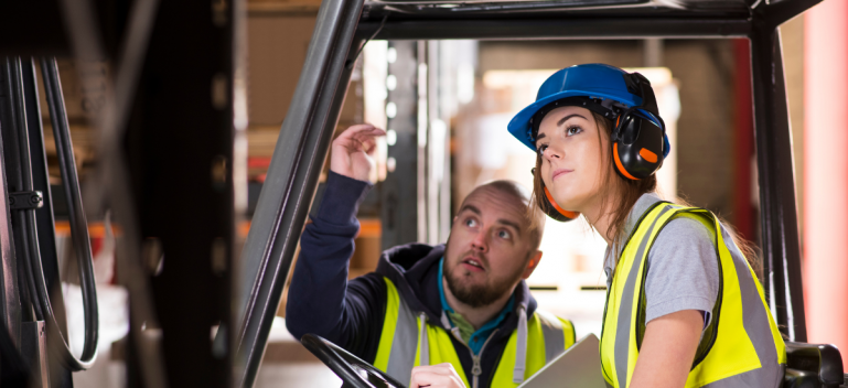Forklift driving student with instructor