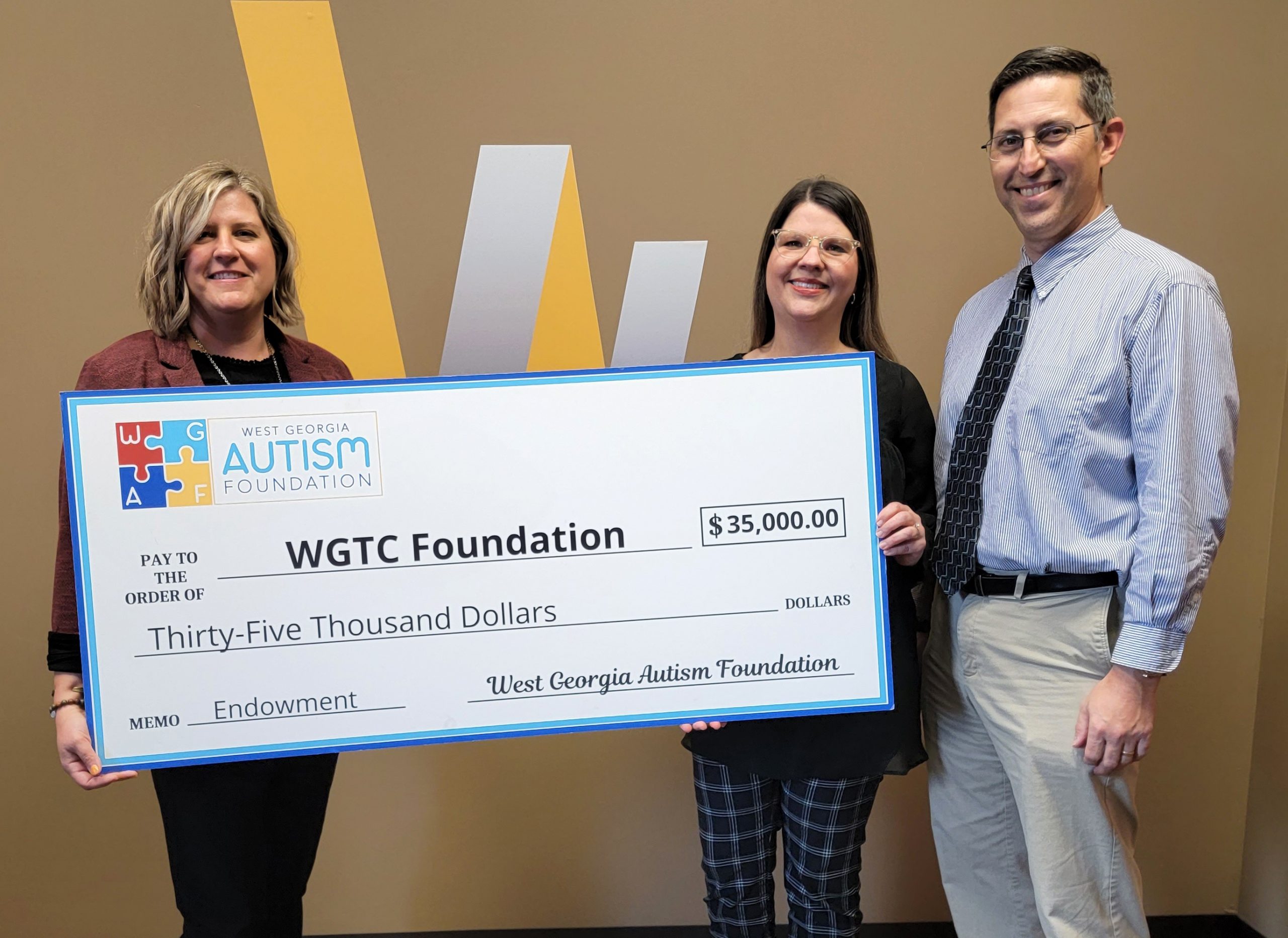 individuals holding big check