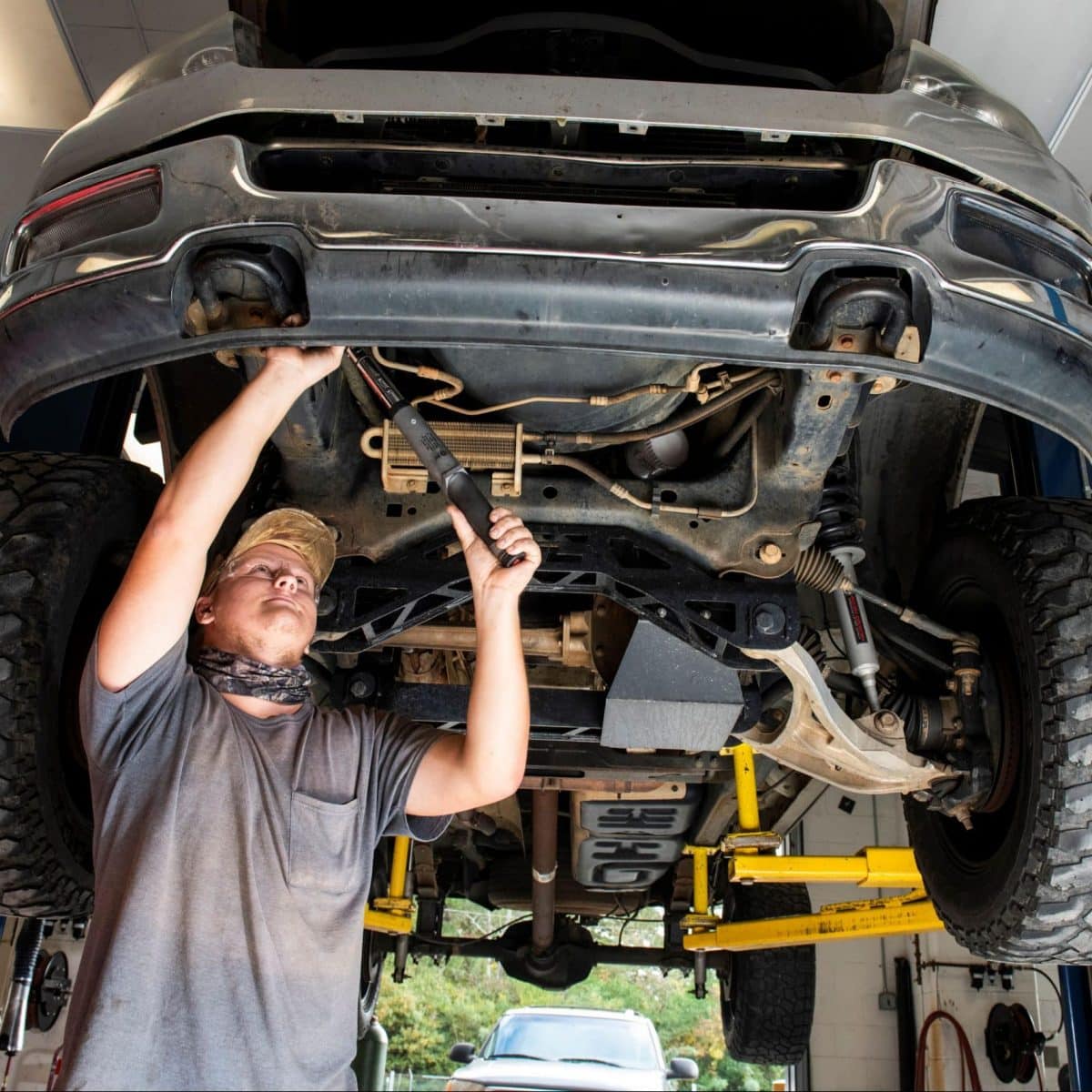 student working on car