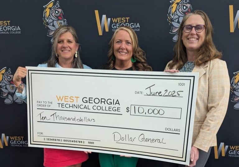 WGTC employees holding a large check